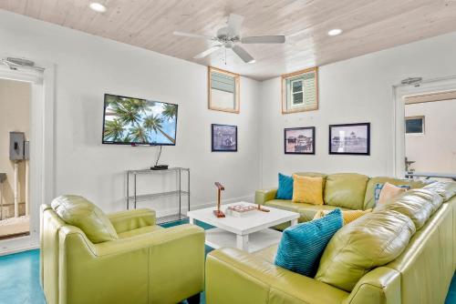 a living room with two yellow couches and a table at 7 Heaven in Port Aransas