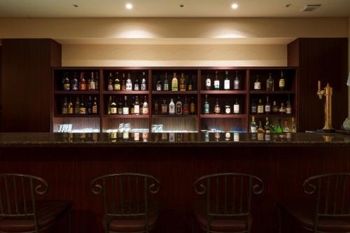 a bar with several bottles of alcohol at GRANDVRIORESORT ISHIGAKIJIMA Ocean's Wing & Villa Garden in Ishigaki Island