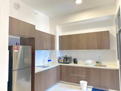 a kitchen with wooden cabinets and a refrigerator at #Netflix #Cuckoo Troika Kota Bharu Homestay 0118 in Kota Bharu