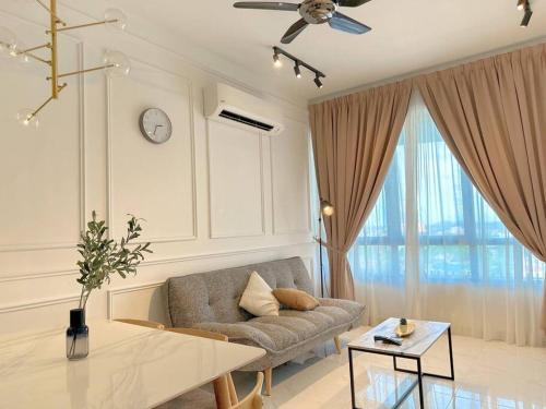 a living room with a couch and a table at Netflix Two Bedroom Troika Kota Bharu Homestay 118 in Kota Bharu