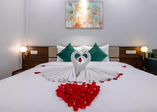 a bed with a swan made out of red roses at TRUONG TIEN HOTEL in Hue