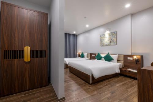 a bedroom with a bed and a wooden door at TRUONG TIEN HOTEL in Hue