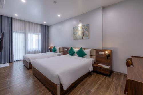 a hotel room with two beds in a room at TRUONG TIEN HOTEL in Hue
