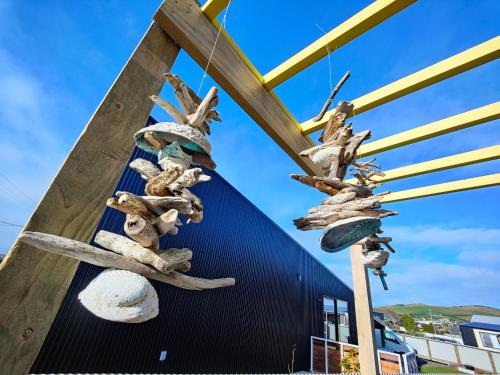 a bunch of bones are hanging on a building at Vitamin Sea Beach House in Riverton