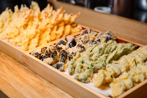a wooden box filled with cheese and other foods at THE BLOSSOM HIBIYA in Tokyo