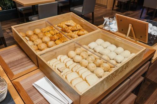 a display of doughnuts and pastries on a table at THE BLOSSOM HIBIYA in Tokyo