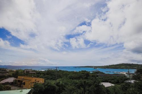 a view of a body of water under a cloudy sky at ヴィラ Cy MOTOBU 沖縄本部町 一棟貸し in Motobu