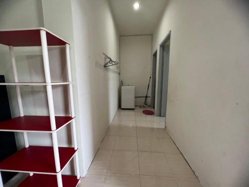 a hallway with a red and white book shelf at Leng Leng Homestay in Sibu