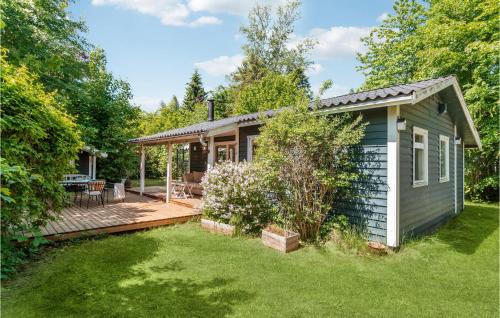 a small house with a deck and a patio at 3 Bedroom Lovely Home In Gilleleje in Gilleleje