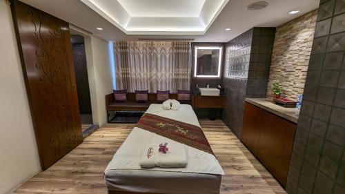 a hospital room with a bed and a sink at The Peninsula Chittagong Limited in Chittagong