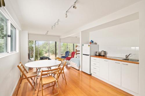 a kitchen and dining room with a table and chairs at Modern Sanctuary by the Silverleaves Beach in Rhyll