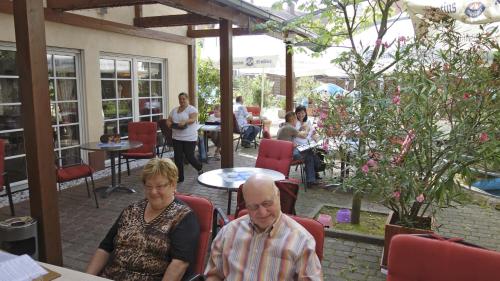 a man and woman sitting at a table in a restaurant at Zum Ochsen in Hauenstein