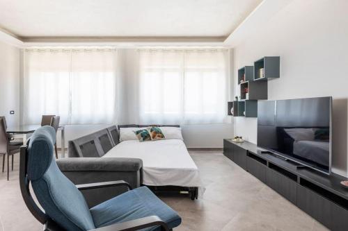 a living room with a couch and a tv at Blu Mediterraneo - Seaview luxury house in Acitrezza