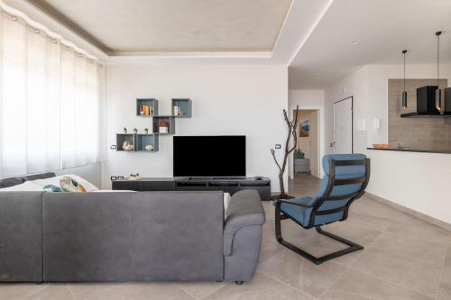 a living room with a couch and a chair at Panoramic Private Parking Elegant Apartment in Aci Castello