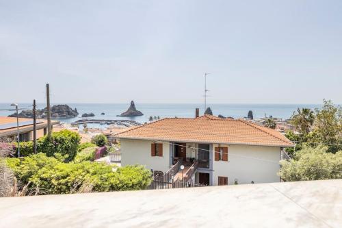 a white house with a view of the ocean at Blu Mediterraneo - Seaview luxury house in Acitrezza