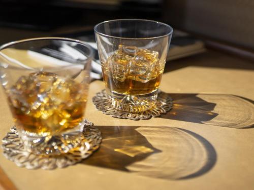 two glasses of whiskey sitting on a table at Hotel New Gaea Itoshima in Itoshima