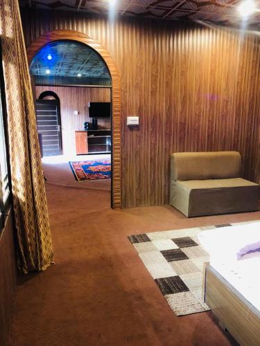 a living room with a couch and an archway in a room at Zara Residence 1 in Swat