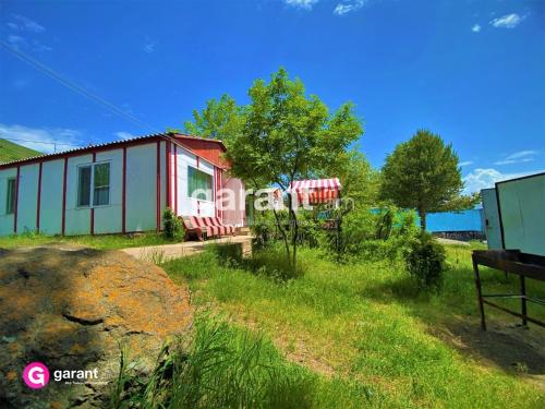 a small house in the middle of a field at Nirvana Resort in Sevan