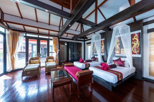 A bed or beds in a room at Phi Phi Natural Resort