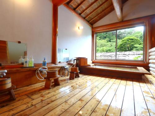 a bathroom with a large window and a mirror at Minshuku Sawaguchi in Agematsu