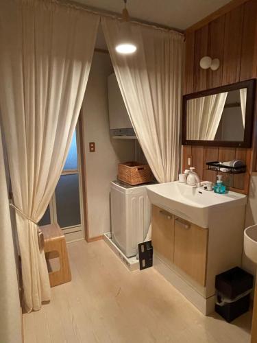 a bathroom with a sink and a mirror at Villa Sense of wonder in Takayama