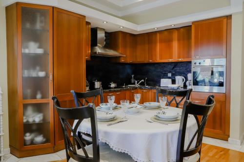 a kitchen with a table with a white table cloth at Pepy's home in Kavala
