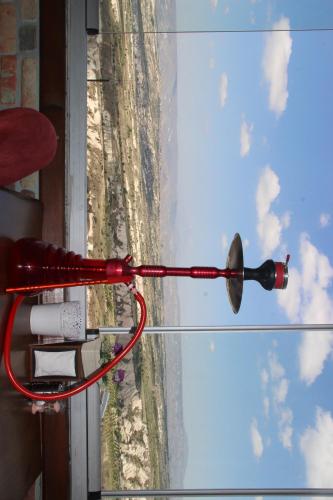 a bottle of wine hanging from a glass window at Uchisar Cave House in Uchisar