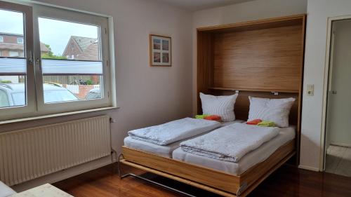 - une chambre avec un lit et une fenêtre dans l'établissement Haus Spökenkieker Wybelsum, à Borkum