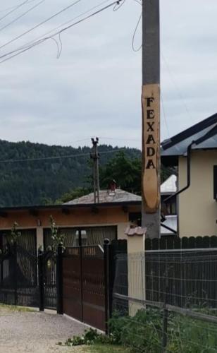 a building with a fence and a sign on it at Fexada Home in Vama