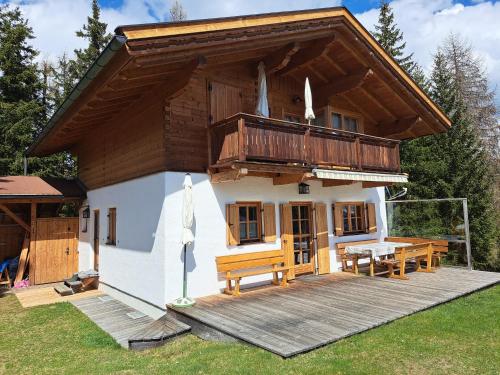 a small house with a deck and a balcony at Chalet Faschingalm in Debant