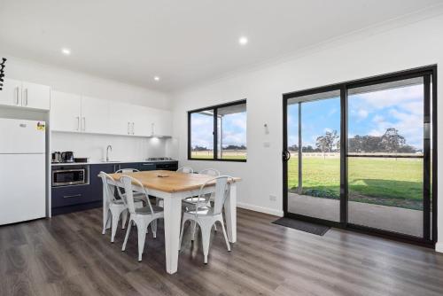 a kitchen and dining room with a table and chairs at Glenowrie Cottage - 2 King Beds - Close to Cadia in Millthorpe