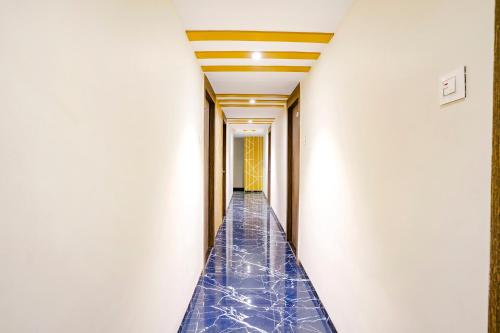 a hallway with blue tiles on the floor and a ceiling at FabExpress Shalimar in Mumbai