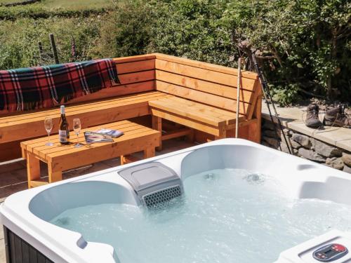 a bath tub with a picnic table and a bench at Rowan in Ulverston