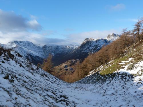 a snow covered mountain with trees and mountains at Cherry in Ulverston