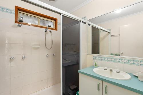 a bathroom with a sink and a shower at 38 Bayview Drive in Cowes