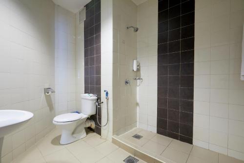 a bathroom with a toilet and a shower and a sink at Grand Pacific Hotel in Kuala Lumpur