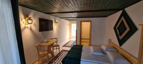 a bedroom with a bed and a table in a room at Fexada Home in Vama