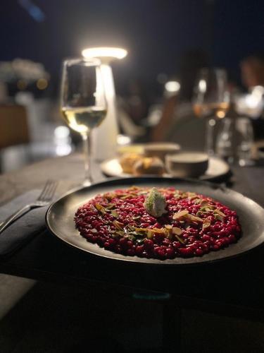 a plate of food on a table with a wine glass at MiraMe Athens Boutique Hotel in Athens