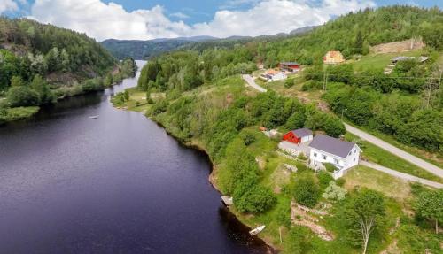 an aerial view of a river with a house next to it at Glamping on idyllic lake, paddle boards & rowboat in Porsgrunn
