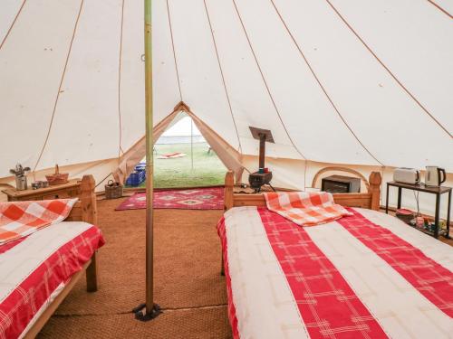 two beds in a tent with a view of a field at Annamay in Worcester