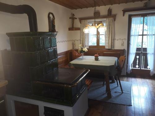 a kitchen with a table and a table and a stove at Haus Widlbrandlehen in Schönau am Königssee