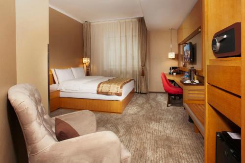 een hotelkamer met een bed en een bureau bij Ramada Ulaanbaatar City Center in Ulaanbaatar