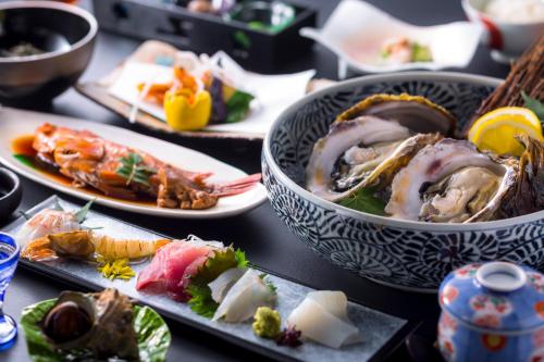a table topped with plates of food on top at Jukaitei in Kyotango