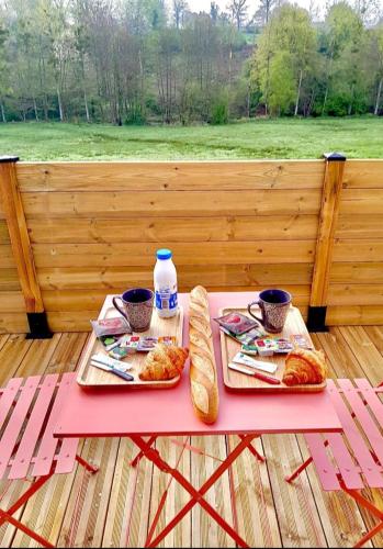 a picnic table with two plates of food and drinks at Love room le temps d'un plaisir in Landisacq