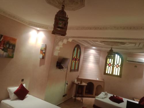 a room with two beds and two stained glass windows at Atlas Resorts in Aït Ourir