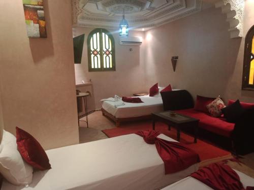 a hotel room with two beds and a living room at Atlas Resorts in Aït Ourir
