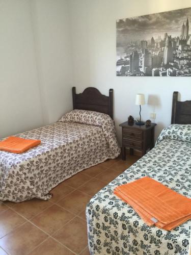 a room with two beds and a table at Isla Canela Appartment in Isla Canela