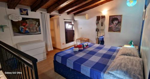 a bedroom with a bed with a blue checkered blanket at Apartment mYourHome in Catania