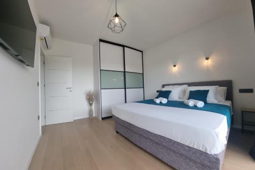 a bedroom with a large bed and a television at Vila Geminos I in Srima