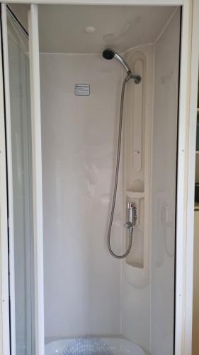 a shower in a bathroom with a sink at 3 Bed Caravan at Parkdean Resort Southview Skegness on a Fishing Lake in Lincolnshire